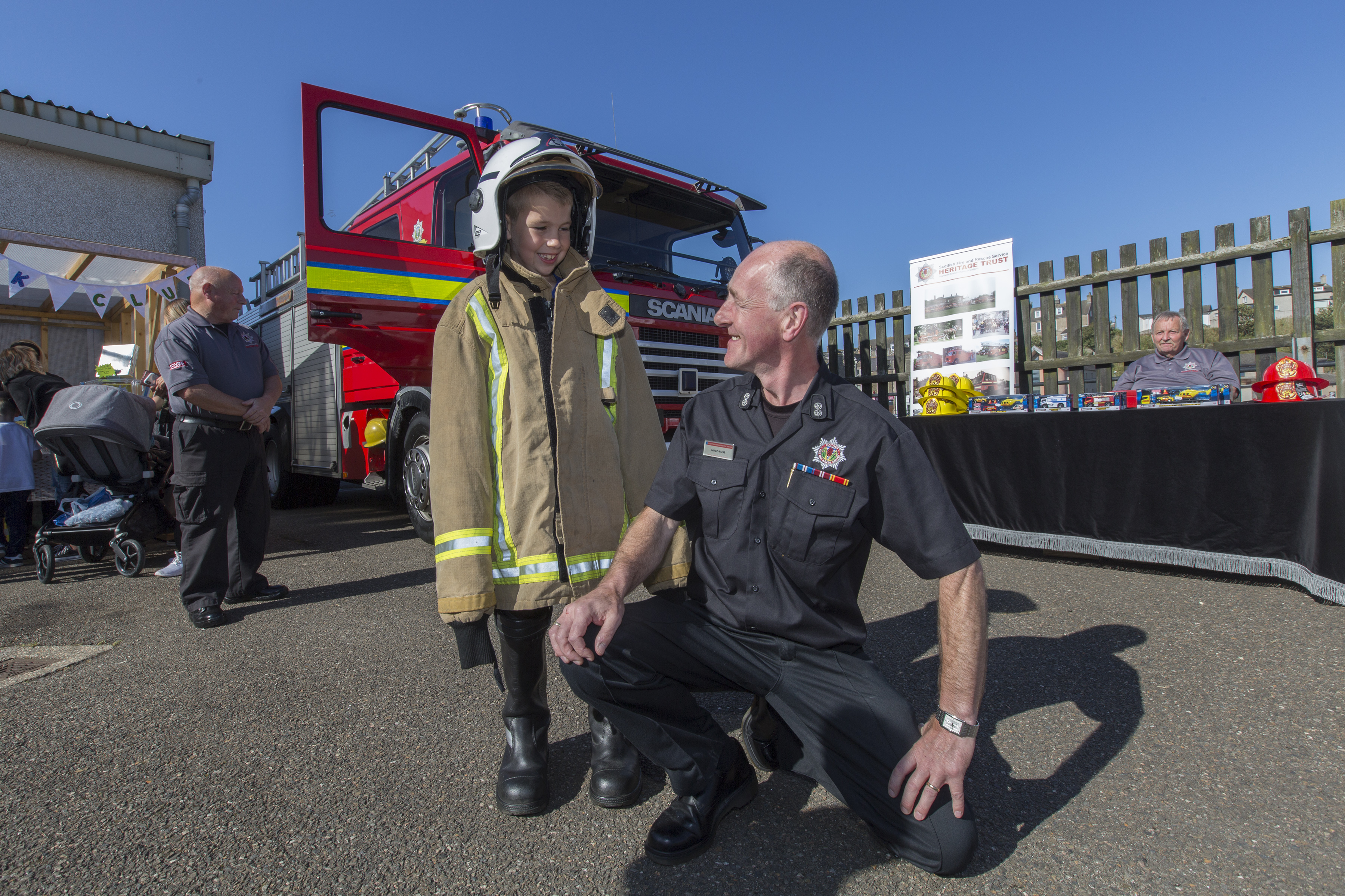 Wick Community Fire Station's acting watch manager Hugo Ross with seven year old Scott Allan