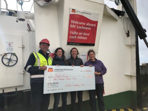 V Loch Nevis crewman Murdo Ferguson presents the Community Fund cheque to representatives of Fèis Eige.