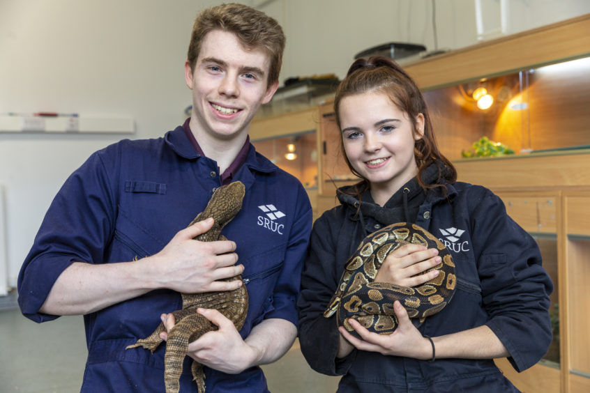 Students Aiden Forrest and Steph Sim with two reptiles from the centre.