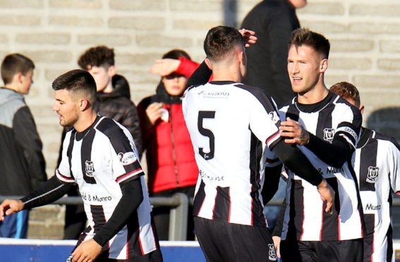Brian Cameron no8 celebrating his goal which put Elgin 1 nil up, with team-mates.