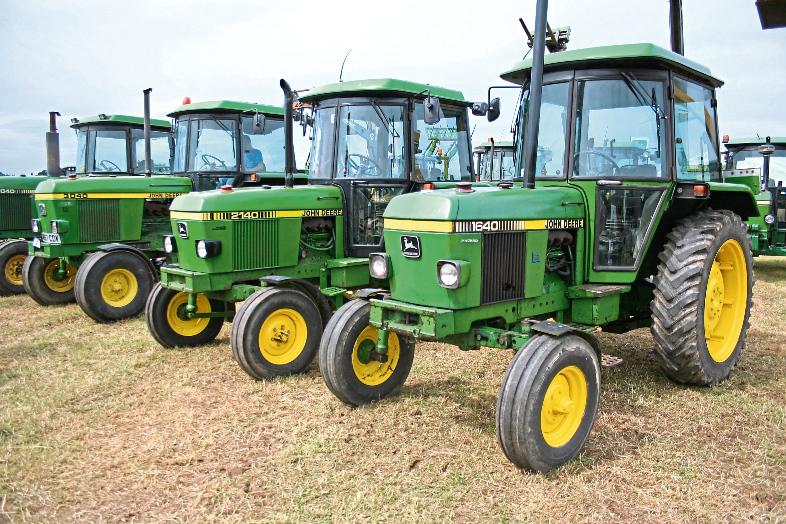 A line up of 1640 2140 and 3040 tractors all fitted with John Deere's SG2 cab at New Deer Show in 2102 when 175 years of John Deere was celebrated.