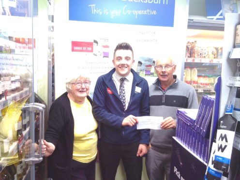 Lesley Glasser and Alistair Henderson receiving the Scotmid cheque.