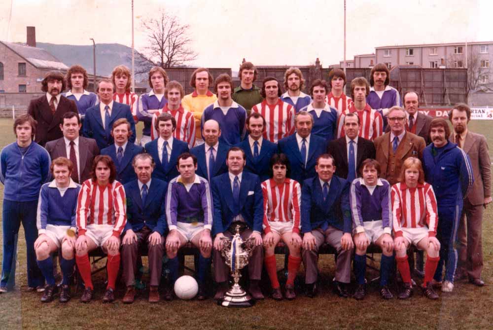 Hugh Crout, pictured in the middle beside the trophy.