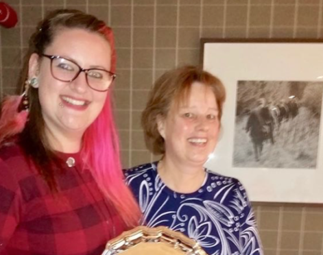 Fiona (right) receives the 'Citizen of the Year' Award from previous holder Rachel Lewis of Action Kintore 'The Bothie'.