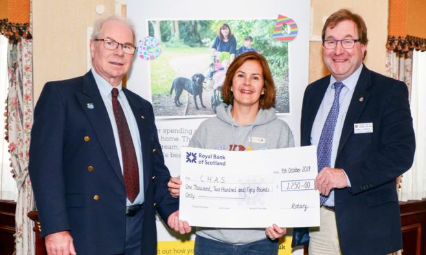 Ormond Smith and James Campbell of Inverness Loch Ness Rotary Club made the award to Ruathy Donald of CHAS