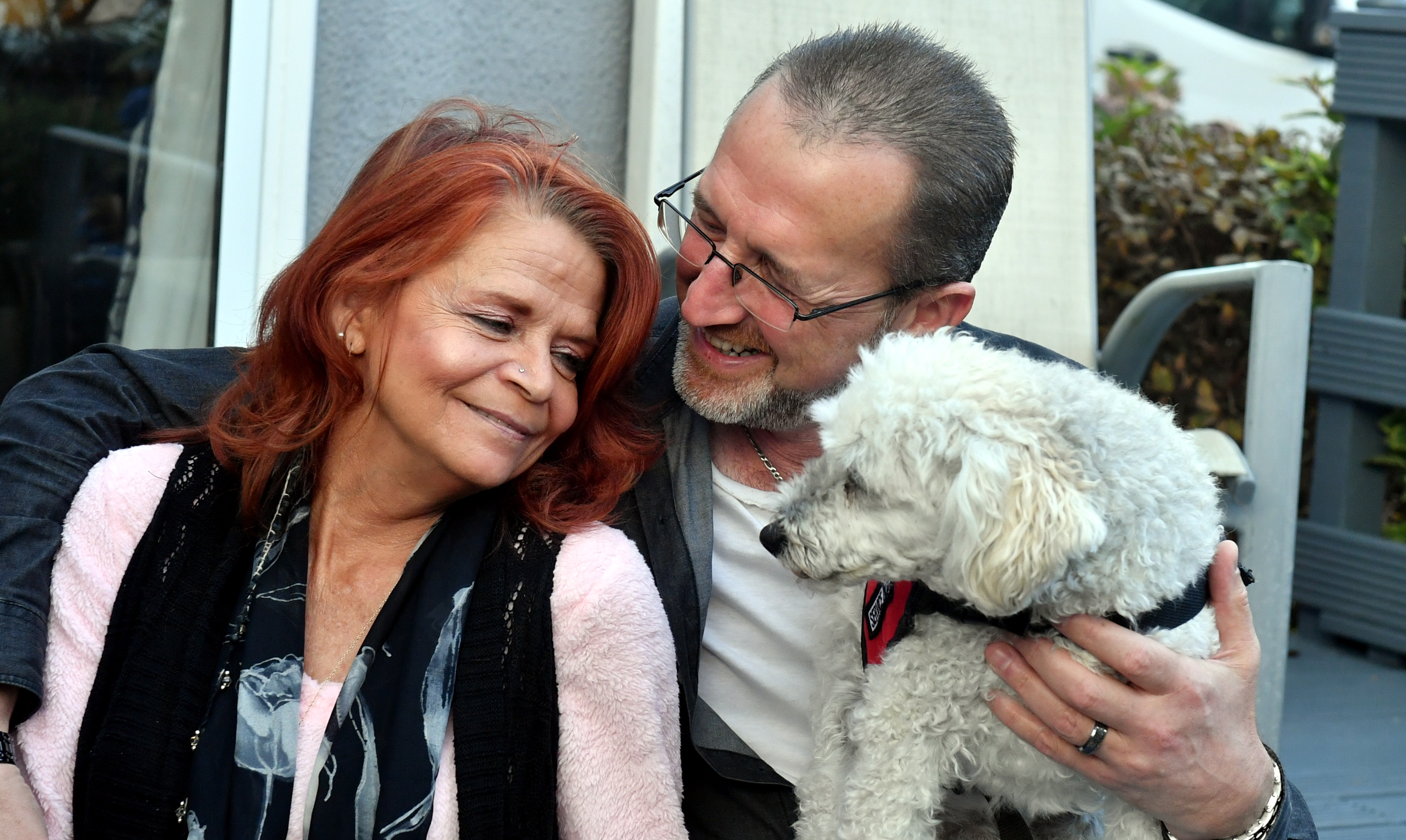 Charlie, the miniature poodle, with owners Susan Martinez and Keith Webster. Pictures by Chris Sumner