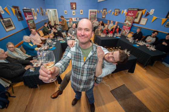 Mike Lord, owner of Dufftown's Whisky Shop, pictured front, who devised the Whisky Colours Festival, and assistant reserve spirits manager Jonny McMillan. Picture by Jason Hedges.