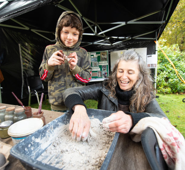 Callum Stables, 8 from Keith is pictured with Becky Little from Rebirth Building who is running an Dorodango making stall.
Picture by JASON HEDGES