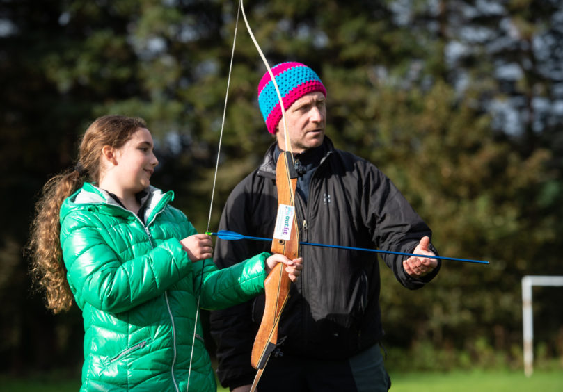 Maisie Anthony, 9 receives archery tuition from Steve Glew from Outfit Moray.
Picture by JASON HEDGES