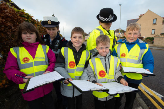 Evie Joss-Allan, Kai Balmer, Keelan Kearns with RAF Police Cpl. Lea Clevett and PC Miller.