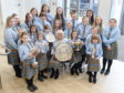 Members of the Falkirk Junior Gaelic School with their trophies and conductor Mary Maclean who herself won the Gold Medal fifty years ago at the Aviemore Mod. Picture by Sandy McCook
