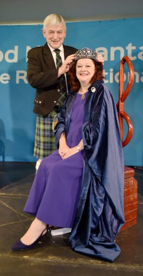 Sandy Macdonald-Jones is crowned as the new Royal National Mod Bard by President Allan Campbell. Picture by Sandy McCook.
