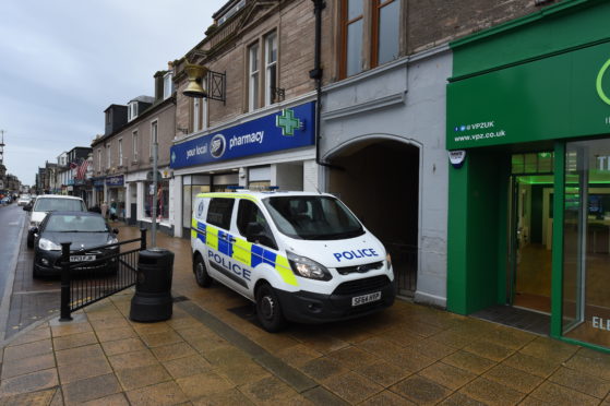 Police at the scene on Nairn High Street after a body was found.