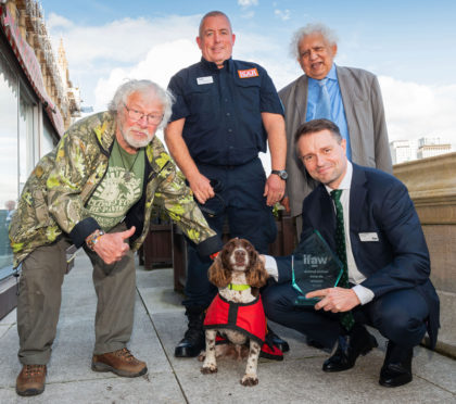 Presenter Bill Oddie, Diesel’s handler Gary Carroll, host Lord Desai (standing) and crouching bottom right IFAW UK Director James Sawyer