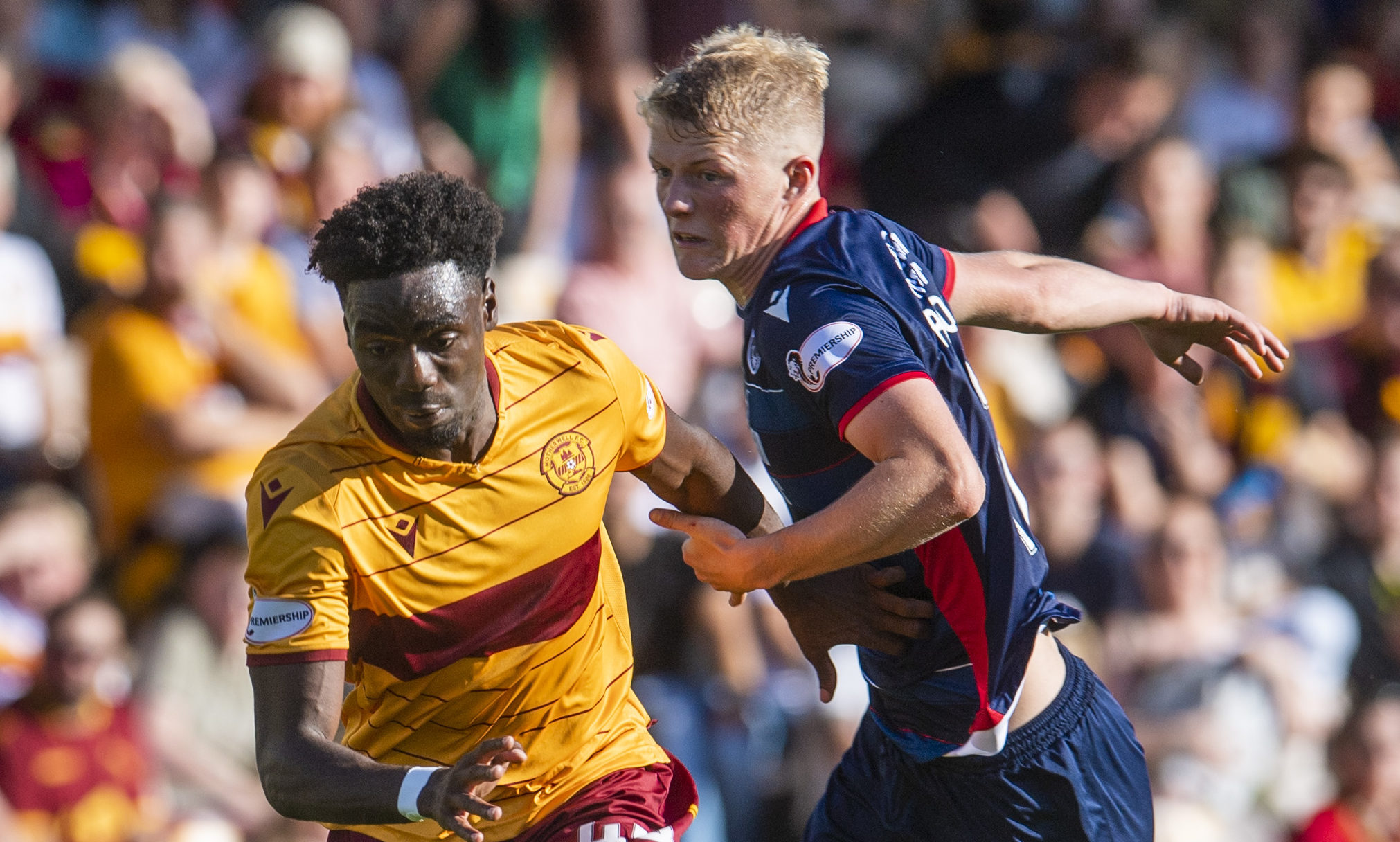 Motherwell's Devante Cole in action with Ross County's Tom Grivosti during the Ladbrokes Premiership match between Motherwell and Ross County at Fir Park.