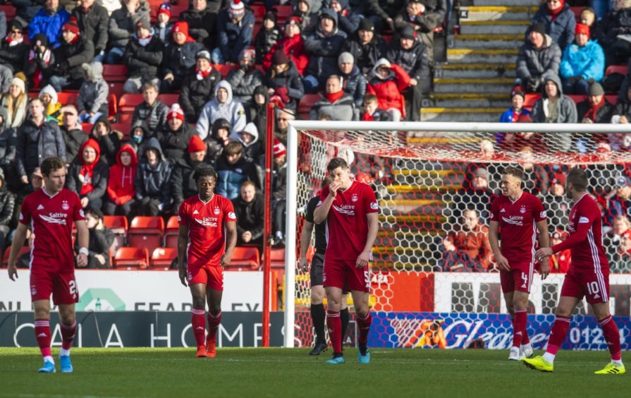 Aberdeen's Scott McKenna (centre) and his teammates look frustrated after James Forrest makes it 3-0