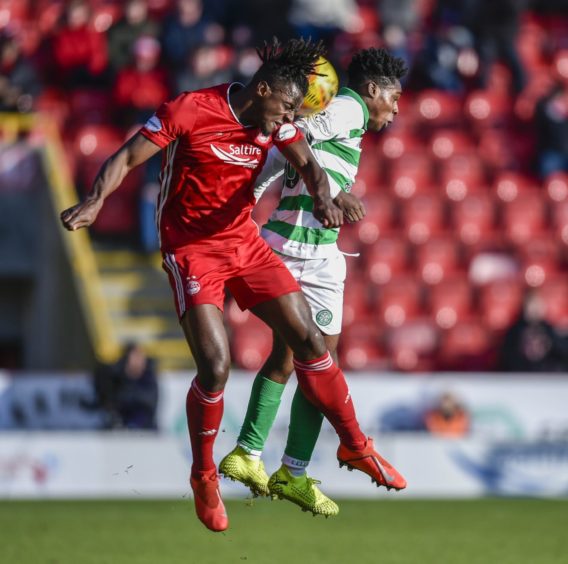 Aberdeen's Greg Leigh (L) in action with Celtic's Jeremie Frimpong last season