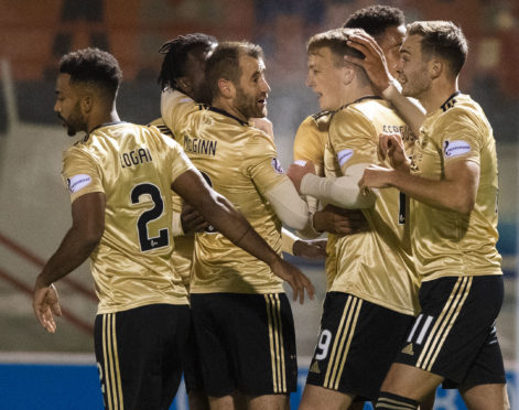 Aberdeen players mob Lewis Ferguson after his goal.