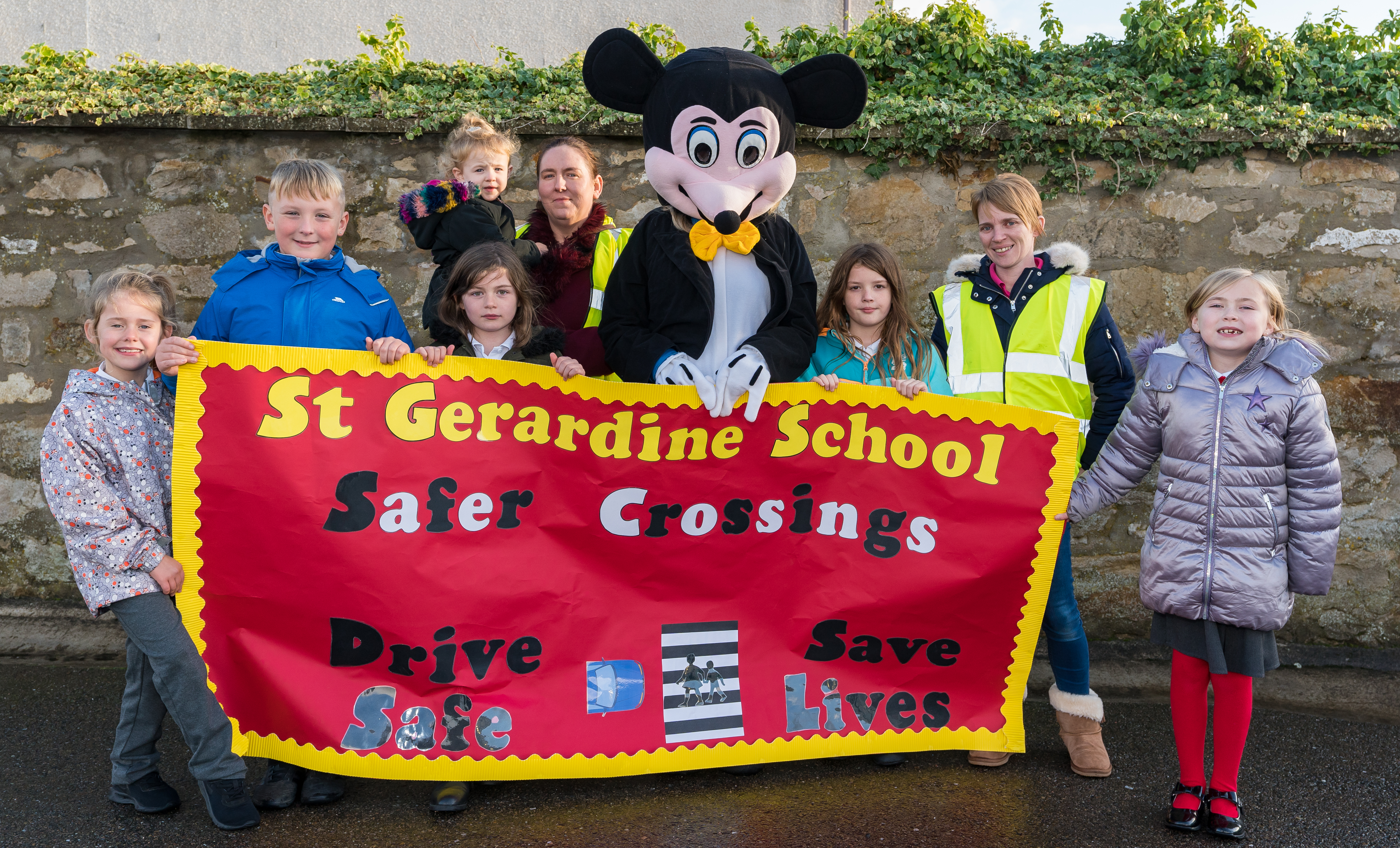 Last October Lossiemouth Community Council bid to collect pennies to make up a mile relative to Safer Crossings with P4 pupils of St Gerardines School. L- R - Flo Selllar, Mathew Simpson, Phoebe Cannon, Louise McBride with her daughter, Carolle Ralph as Mickey, Charlotte Stewart, Kirsty Middleton and Taylor Murray