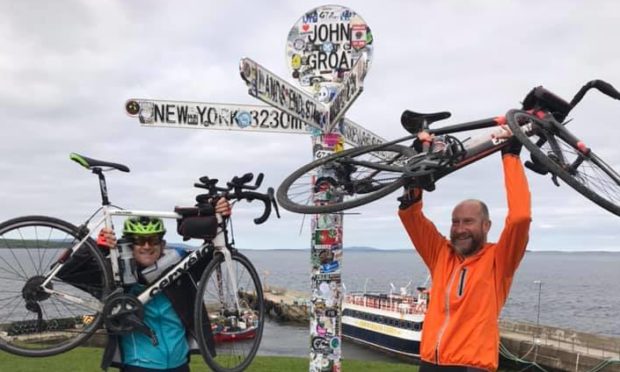 Scott Cummings and Paul Beaumont celebrating after reaching John O'Groats in 14 days