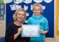 MSP Gillian Martin with one of the Fetterangus pupils awarded for their glass recycling song