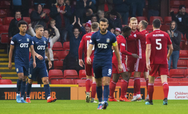 The Aberdeen players celebrate Sam Cosgrove's goal.