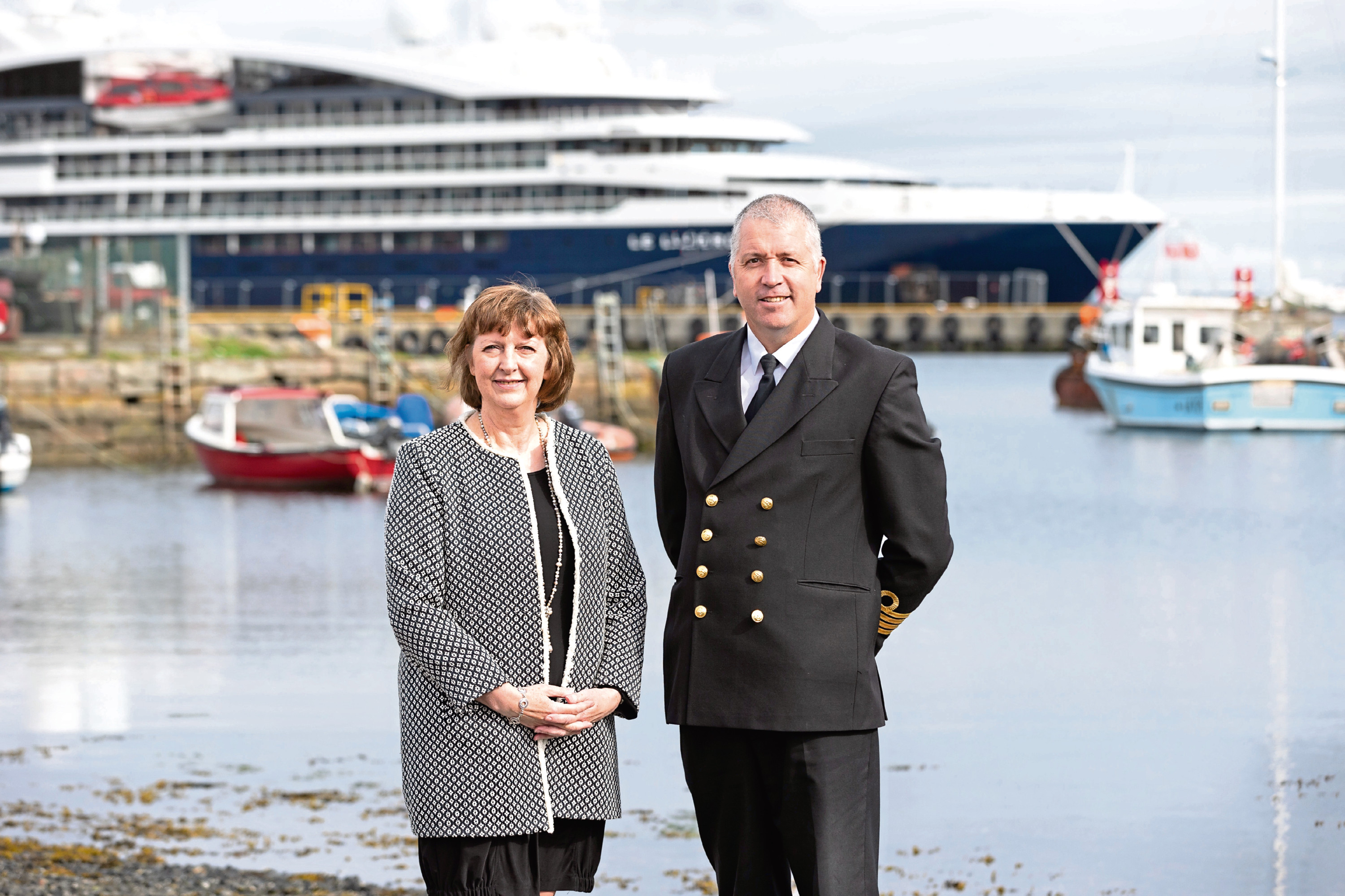 Lerwick Port Authoritys Sandra Laurenson,   and her successor-designate as Chief Executive, Captain Calum Grains, with the cruise ship, Le Laperouse, in the background
