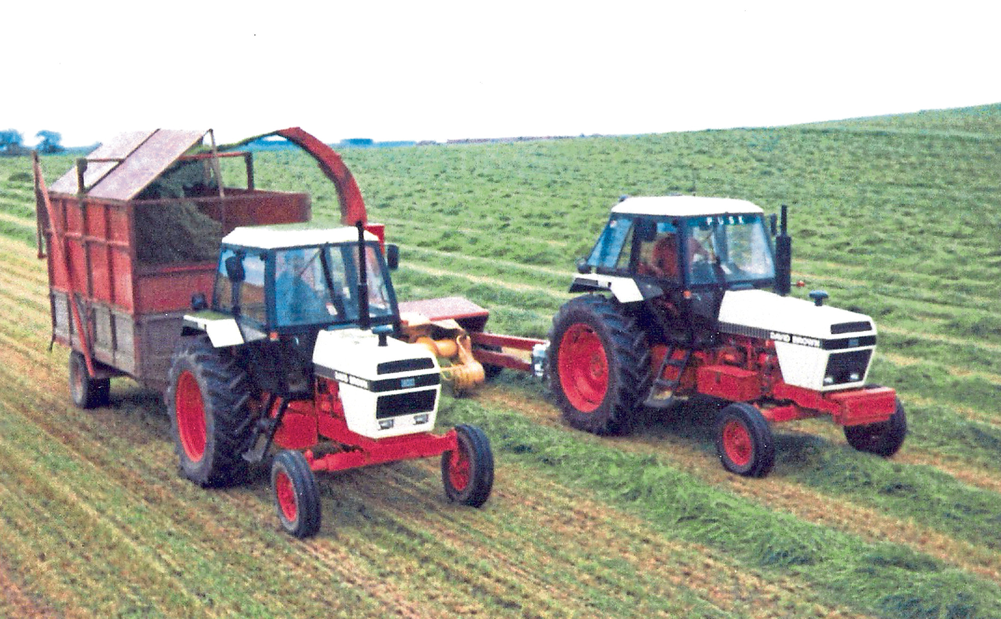 Two 90 series tractors, a 1690 on the forage harvester and a 1490 on the trailer work hard at lifting the silage crop in the 1980s.