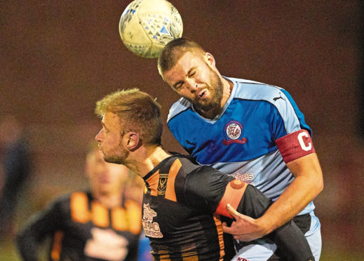 Cameron Bowden wins a header for Turriff.