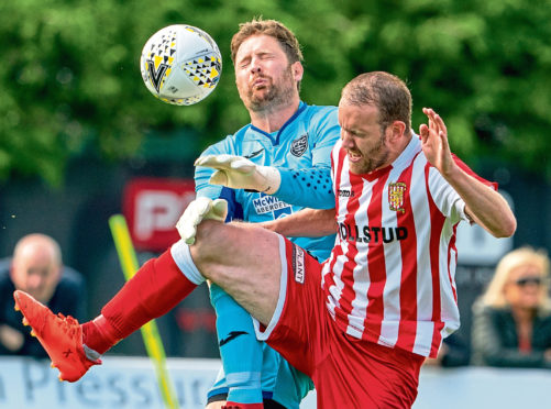 Fraserburgh keeper Paul Leask charges down Formartine's Garry Wood.