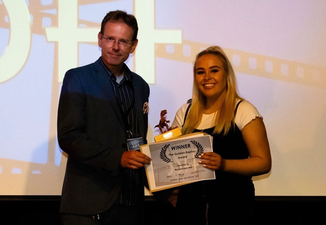 Katie Low accepting the Golden Raptor Award at the Scottish Short Film Festival