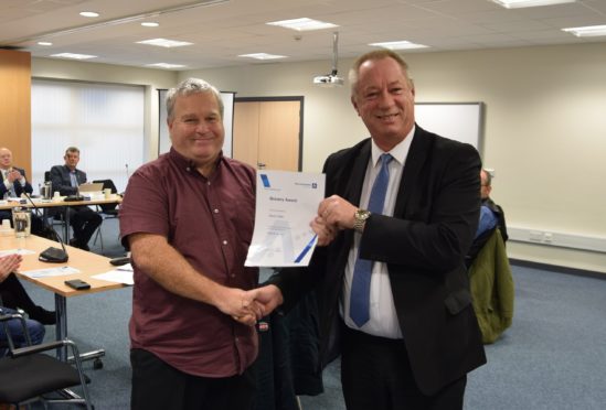 Chairman Andy Kille giving one of the rescuers Kevin Clark his award