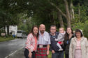 Alltsigh residents Duncan McIntosh, Andrew Park, Maya Park, Yvonne McIntosh and May McIntosh with Kate Forbes MSP where the planned pavement will be installed