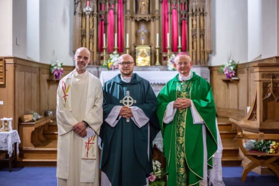 Area Dean Father Colin Stewart, Father Piotr, and Bishop Hugh at the installation mass