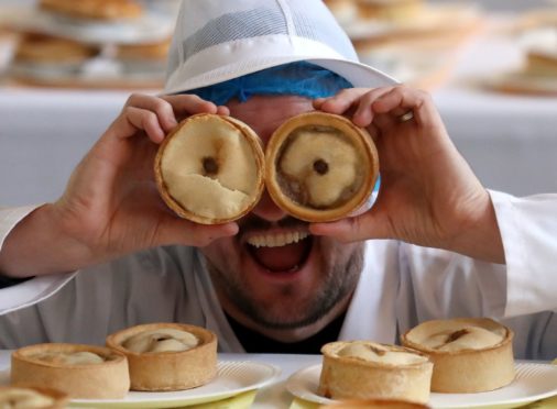 Outlander star Scott Kyle helps judge the entries during the search for the 2020 World Scotch Pie Champion at Carnegie Conference Centre, Dunfermline.