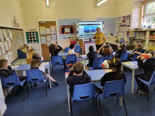 Pupils using the VR headsets at Daviot Primary.