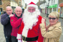 Santa came early to Dingwall yesterday ahead of the town's Christmas Lights switch on following work done in the town to erect his years lights.  Also in the photograph are Andrew Macivor, community councillor, Jack Shepherd, Chairman of Dingwall Community Council and Di Agnew Highland Council Ward Manager. Picture by Sandy McCook