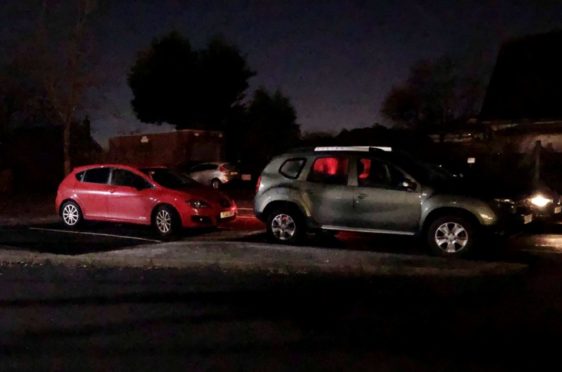 Car lights illuminate parked cars in the car park next to the community centre on Gordon Terrace, Dyce. 
Picture by Kaitlin Easton.