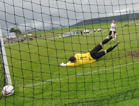 Scott Graham nets a penalty past Buckie goalkeeper Kevin Main.