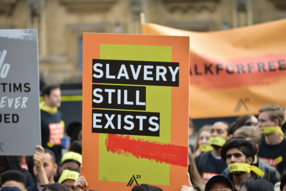 LONDON, UNITED KINGDOM - OCTOBER 14: People marching against modern slavery through London wearing face masks representing the silence of modern slaves in forced labour and sexual exploitation on October 14, 2017 in London, England.

PHOTOGRAPH BY Mathew Chattle / Barcroft Images (Photo credit should read Mathew Chattle / Barcroft Media via Getty Images / Barcroft Media via Getty Images)