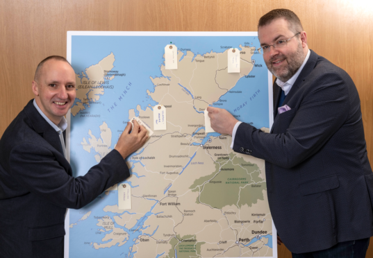 Chris Taylor, VisitScotland Regional Leadership Director and Jóhannes Þór Skúlason, of the Icelandic Travel Industry Association, who was the keynote speaker at the Highland Tourism Conference, are pictured with a map of the Highlands onto which delegates were encouraged to share and pin their hidden gems, with the idea of distributing visitors to new locations right cross the Highlands which they might not have thought of visiting.