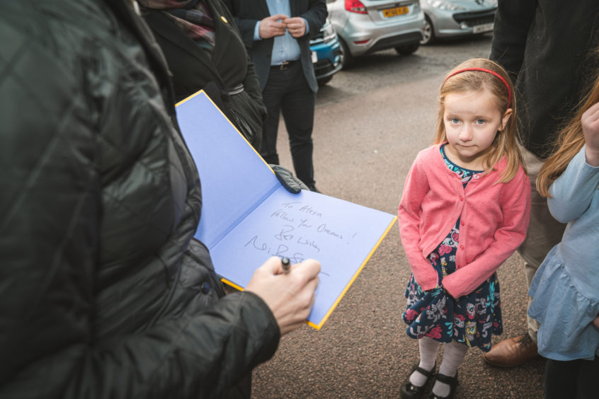 Nicola Sturgeon signs a book for a child at BrewDog. Picture by Jamie Ross.