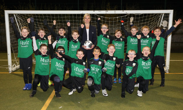 Primary 5 Milltimber school football team with Louise Craig, sales advisor for Muir Homes.