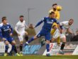 Montrose keeper Aaron Lennox punches clear to deny Rory McAllister.