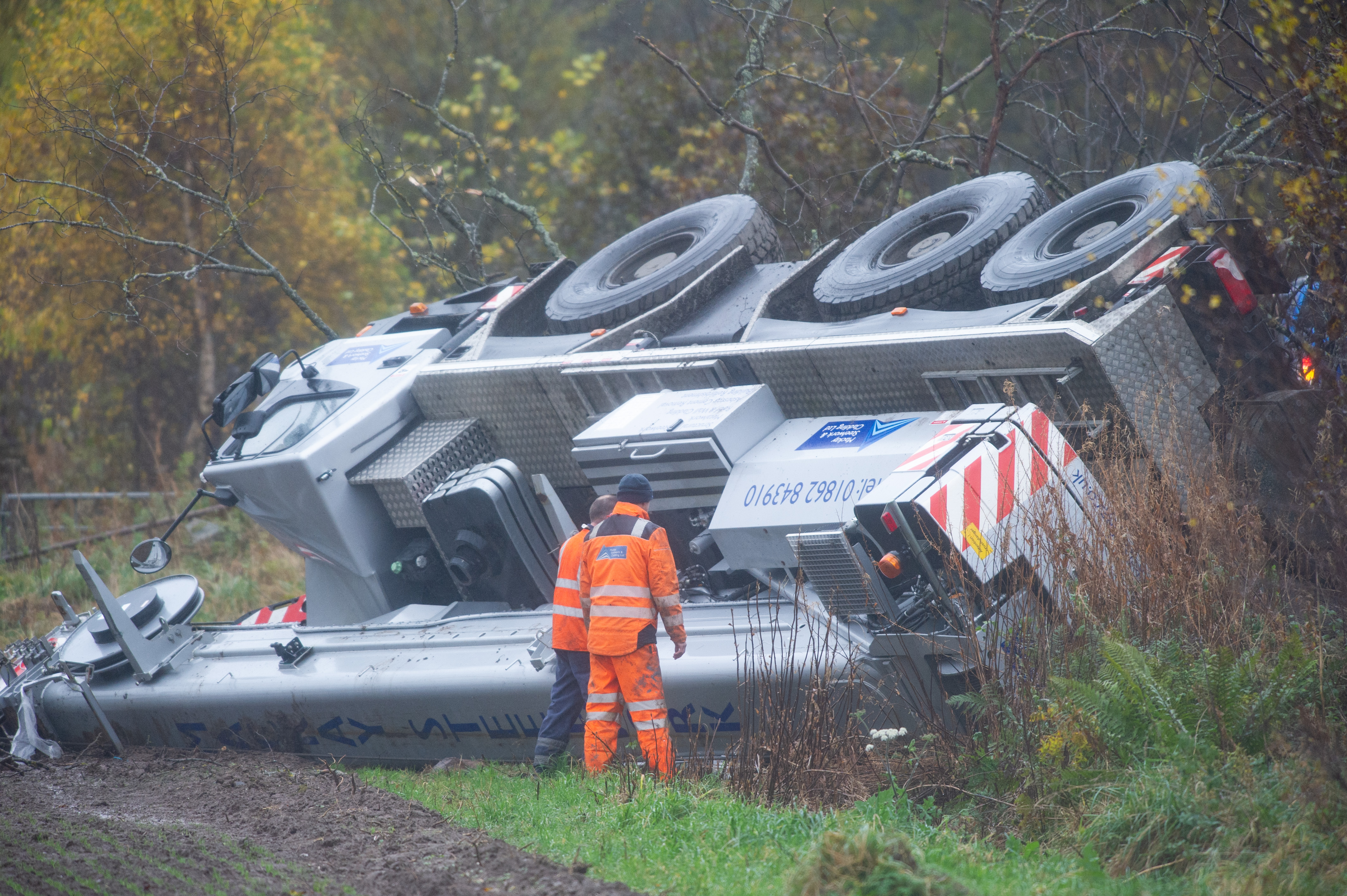 A crane goes off the road on the A96 Elgin to Forres at Alves, Moray.