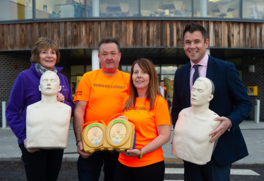 Pictured: Margaret Stenton, trustee of Gordon and Ena Baxter Foundation, Gordon and Sandra McKandie and Elgin Academy head teacher Kyle Scott.