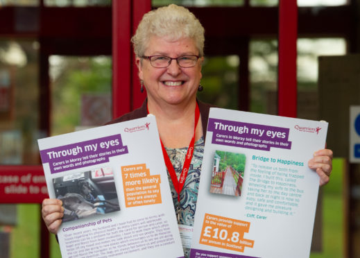 Jane Hill, family wellbeing worker with Quarriers, is pictured at the photo exhibition currently on display.