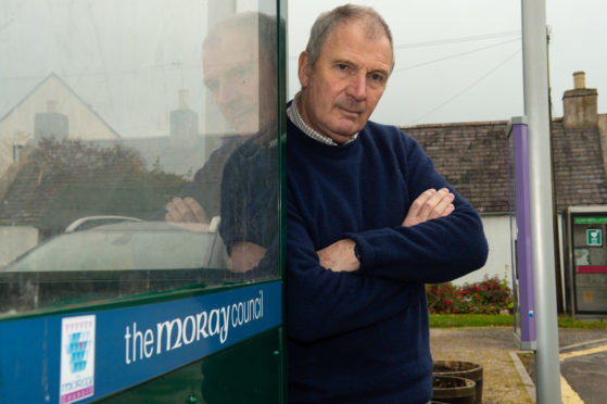 Alan Clarke at a bus stop in Garmouth.