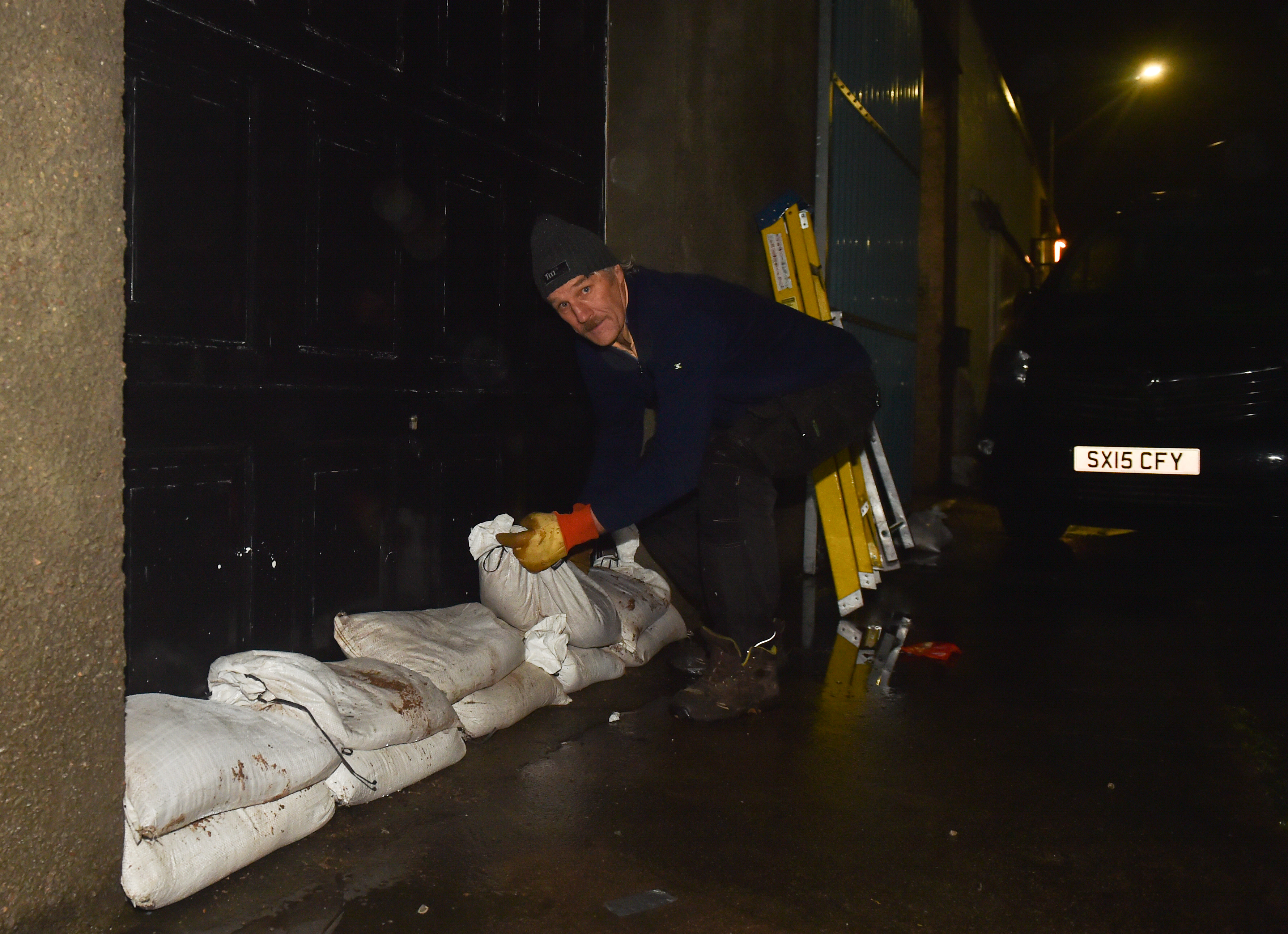 Landlord Frank Ralph is pictured placing sandbags at one of his properties.

Pictures by JASON HEDGES