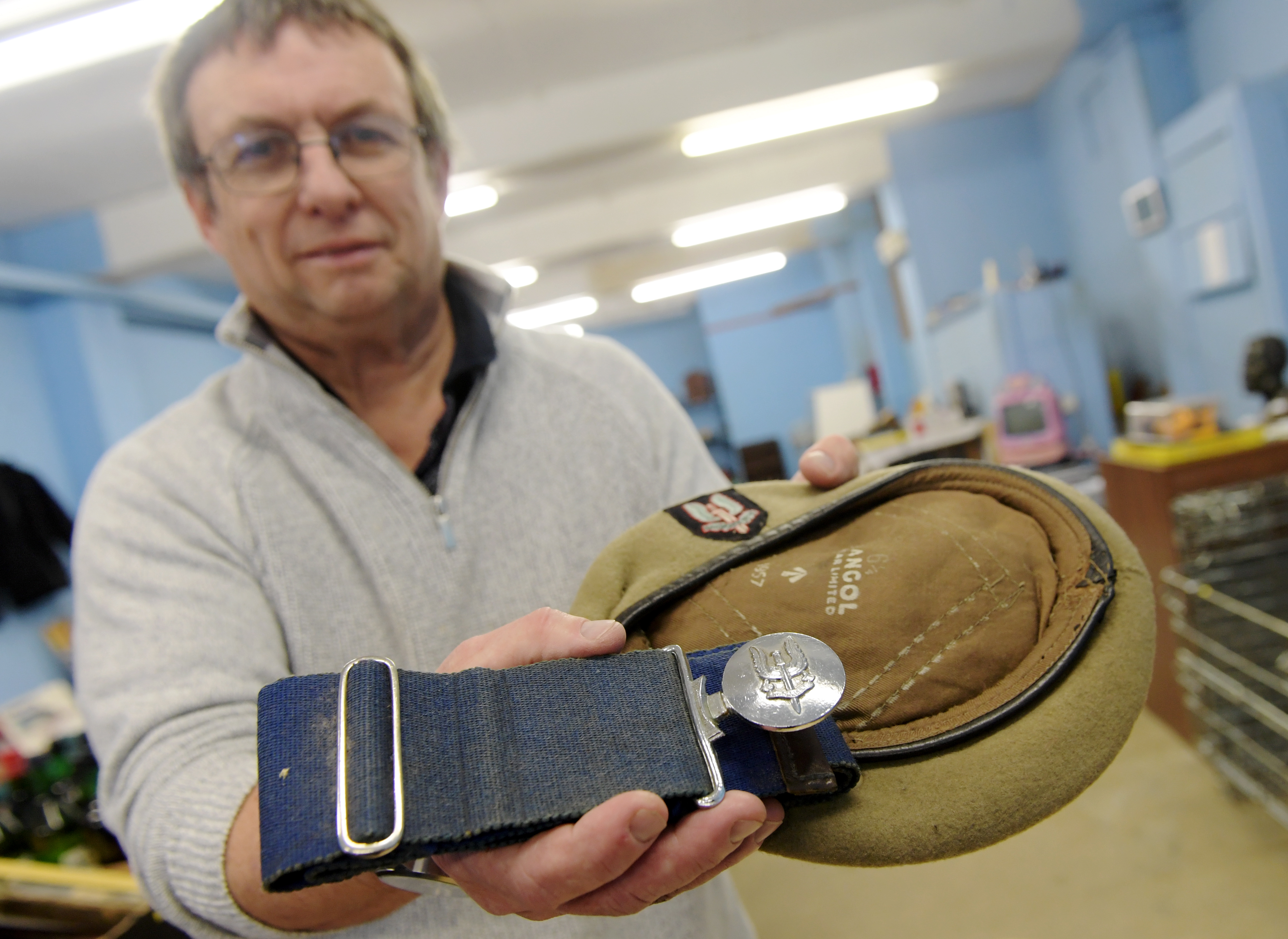 Inverbervie auctioneer Dave Smith pictured with the rare soldier's belt and hat that he has found. 

Picture by KATH FLANNERY